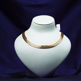 Flat mirror-polished gold collar necklace on a white bust